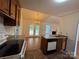 Bright kitchen view to dining area with island sink, and granite counters at 2504 Faircroft Way, Monroe, NC 28110