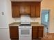 Kitchen with wood cabinets, granite countertops and white appliances at 2504 Faircroft Way, Monroe, NC 28110