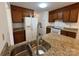 Well-lit kitchen featuring granite countertops, stainless steel faucet, and dark wood cabinetry at 2504 Faircroft Way, Monroe, NC 28110