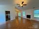 Bright living room featuring a fireplace, hardwood floors and many windows allowing lots of natural light at 2504 Faircroft Way, Monroe, NC 28110