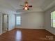 Spacious main bedroom featuring a ceiling fan, laminate flooring, and two windows at 2504 Faircroft Way, Monroe, NC 28110