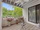 View of a relaxing balcony space with a small table, potted plants, and a ceiling fan at 2719 Selwyn Ave # 20, Charlotte, NC 28209