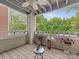 Inviting balcony with wooden floors, white railing, ceiling fan, and views of lush trees at 2719 Selwyn Ave # 20, Charlotte, NC 28209