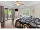 Primary bedroom with a ceiling fan, window nook, private balcony, and hardwood floors at 2719 Selwyn Ave # 20, Charlotte, NC 28209