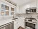Modern kitchen features white cabinets, stainless steel appliances, and a bright window at 2719 Selwyn Ave # 20, Charlotte, NC 28209
