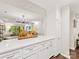 Open kitchen layout with view to dining and living areas, showcasing stainless appliances and white countertops at 2719 Selwyn Ave # 20, Charlotte, NC 28209