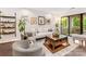 Bright living room features hardwood floors, modern decor, and sliding doors to a private balcony at 2719 Selwyn Ave # 20, Charlotte, NC 28209