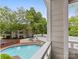Community pool with lounge chairs, staircase access, and views of surrounding mature trees at 2719 Selwyn Ave # 20, Charlotte, NC 28209