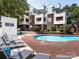 Community pool with lounge chairs and access to residential building at 2719 Selwyn Ave # 20, Charlotte, NC 28209
