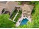 An aerial view of the home featuring a pool, patio, lush landscaping, and manicured lawn at 2915 Cutter Ct, Waxhaw, NC 28173
