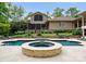 Backyard featuring a pool, hot tub, patio, stone retaining wall, and a covered patio at 2915 Cutter Ct, Waxhaw, NC 28173