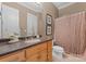 Cozy bathroom featuring a vanity with a solid surface countertop, a shower with a curtain, and tiled floors at 2915 Cutter Ct, Waxhaw, NC 28173