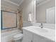 Cozy bathroom featuring a tub with tiled walls, a white vanity, and a framed mirror at 2915 Cutter Ct, Waxhaw, NC 28173