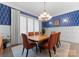 A dining room featuring a chandelier, seating for eight, and paneled walls at 2915 Cutter Ct, Waxhaw, NC 28173