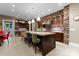 Bright kitchen featuring an island with seating, stone wall accents, custom cabinets, and modern lighting fixtures at 2915 Cutter Ct, Waxhaw, NC 28173