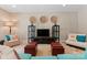 Inviting living room with stylish decor, featuring dual ottomans, accent chairs, and unique wall art at 2915 Cutter Ct, Waxhaw, NC 28173