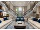 Elegant living room featuring a dual staircase, soaring ceilings, and plenty of natural light at 2915 Cutter Ct, Waxhaw, NC 28173