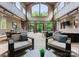 Open-concept living space with stone floors, high ceilings, ample seating, and serene outdoor views at 2915 Cutter Ct, Waxhaw, NC 28173