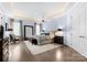 Spacious main bedroom with a sitting area, soft lighting, a ceiling fan, and a large mirror at 2915 Cutter Ct, Waxhaw, NC 28173