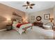 Elegant bedroom with textured wall, ceiling fan, side table, and woven furniture, offering a serene retreat at 2915 Cutter Ct, Waxhaw, NC 28173