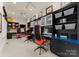 Home office featuring built-in shelving, dual workstations, and comfortable seating for a productive workspace at 2915 Cutter Ct, Waxhaw, NC 28173