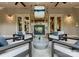 Cozy outdoor seating around a stone fireplace with stone floors and views into the home at 2915 Cutter Ct, Waxhaw, NC 28173