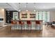 Modern wet bar with pendant lighting, bar stool seating and open shelving at 2915 Cutter Ct, Waxhaw, NC 28173