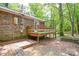 A weathered back deck offers outdoor living space, surrounded by lush trees at 316 Anne Ave, Waxhaw, NC 28173