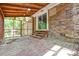 This covered back porch features a brick exterior and a rustic wood ceiling at 316 Anne Ave, Waxhaw, NC 28173