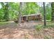 View of the home's backyard, featuring mature trees, a back deck, and a screened-in porch at 316 Anne Ave, Waxhaw, NC 28173