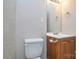 This bathroom features a toilet, sink with vanity, and a mirror at 316 Anne Ave, Waxhaw, NC 28173