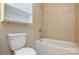 This bathroom features a standard toilet and a tub/shower combo with tile surround at 316 Anne Ave, Waxhaw, NC 28173