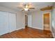This bedroom includes a closet, ceiling fan and wood-look flooring at 316 Anne Ave, Waxhaw, NC 28173
