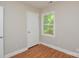 This bedroom features wood-look flooring and a window for natural light at 316 Anne Ave, Waxhaw, NC 28173