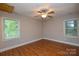 This bedroom has wood-look floors, a ceiling fan, and two windows at 316 Anne Ave, Waxhaw, NC 28173