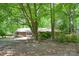 Charming brick home nestled among mature trees with a spacious front yard at 316 Anne Ave, Waxhaw, NC 28173