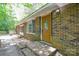 Close up of brick home and front door with adjacent garden and walkway at 316 Anne Ave, Waxhaw, NC 28173