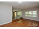 Spacious living room showcasing hardwood floors and natural light from large windows at 316 Anne Ave, Waxhaw, NC 28173