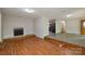 Open-concept space showcasing a fireplace, access to kitchen, and beautiful hardwood floors at 316 Anne Ave, Waxhaw, NC 28173