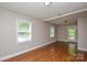 This living room features laminate floors, neutral paint, and two windows at 316 Anne Ave, Waxhaw, NC 28173