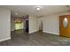 Spacious living area with vinyl floors, view to screened porch, and front entry at 316 Anne Ave, Waxhaw, NC 28173