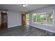 Bright living room featuring an entry door, large window and vinyl flooring at 316 Anne Ave, Waxhaw, NC 28173