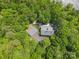 Aerial perspective of home nestled among mature trees, showcasing the property's privacy at 3165 Laurel Ridge Nw Rd, Hickory, NC 28601