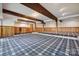 Large basement area featuring wood paneling, exposed beams, and blue carpet at 3165 Laurel Ridge Nw Rd, Hickory, NC 28601