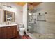 This bathroom offers an updated vanity with a glass shower enclosure with stone flooring at 3165 Laurel Ridge Nw Rd, Hickory, NC 28601