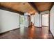 This bedroom features a wood ceiling, hardwood floors, and a large sliding glass door to an enclosed porch at 3165 Laurel Ridge Nw Rd, Hickory, NC 28601