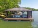 Covered boat house with boat storage on a serene lake, with a built-in shed at 3165 Laurel Ridge Nw Rd, Hickory, NC 28601