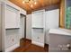 This large walk-in closet has custom shelving and drawers, and hardwood floors at 3165 Laurel Ridge Nw Rd, Hickory, NC 28601