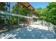 Rear exterior showcasing large deck and expansive windows overlooking the surrounding trees at 3165 Laurel Ridge Nw Rd, Hickory, NC 28601