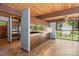Open kitchen with tile floors, light blue walls and view of the back deck through big windows at 3165 Laurel Ridge Nw Rd, Hickory, NC 28601